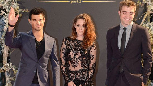 Kristen Stewart wears a revealing lace and sequin jumpsuit at Breaking Dawn premiere
